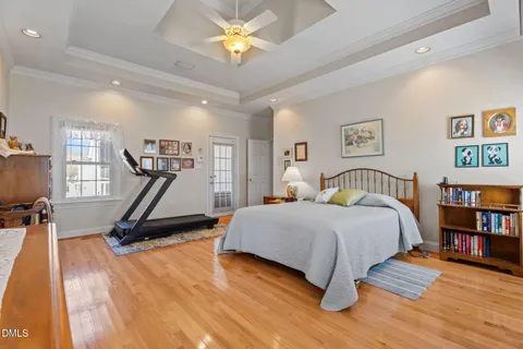 a bath room with a sink and mirror with bathtub