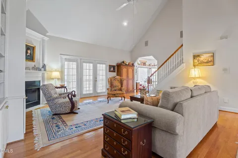 a living room with fireplace furniture and a large window