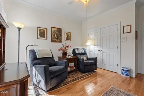 a living room with furniture a flat screen tv and a window