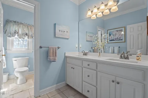 a living room with furniture and a lamp