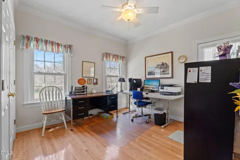 a view of a workspace with furniture and a window