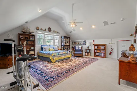 a living room with furniture and a pool table