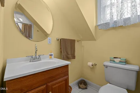 a living room with furniture a flat screen tv and a rug