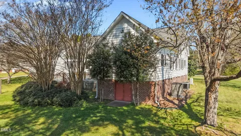 a backyard of a house with lots of green space and fountain
