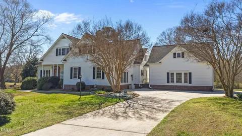 a front view of a house with a yard outdoor seating and yard