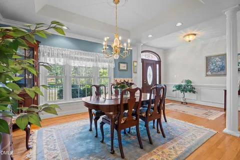 a living room with fireplace furniture and a potted plant
