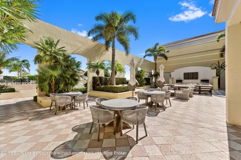 a view of a patio with dining table and chairs with potted plants