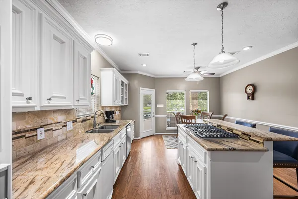 a kitchen with a stove window and cabinets