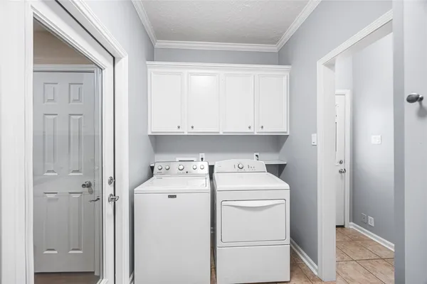 a view of washer and dryer with bathroom in the background