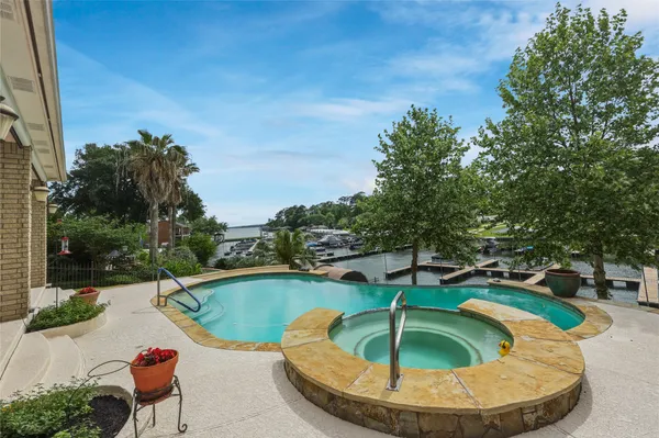 a view of a swimming pool with a yard