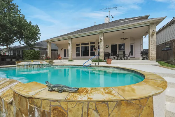 a view of a house with swimming pool and sitting area