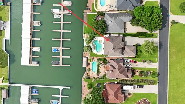 an aerial view of a residential apartment building with a yard