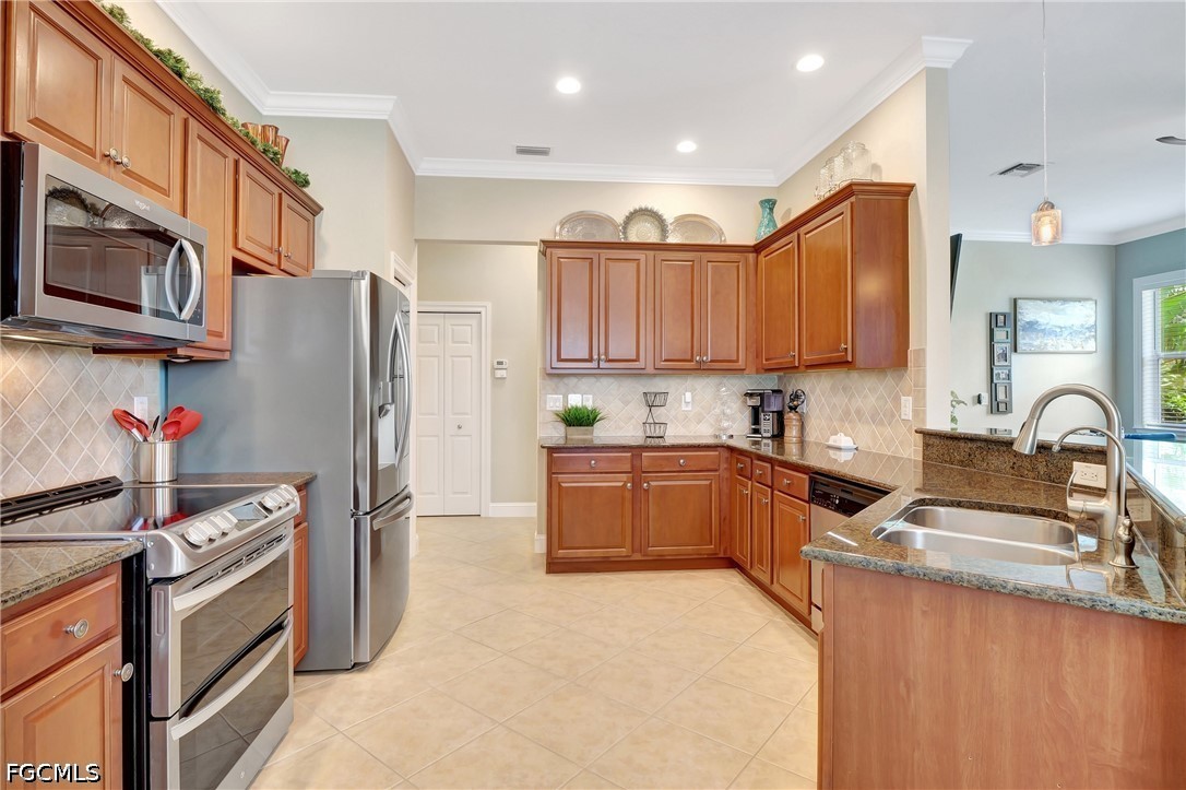 11230 Suffield Street Fort Myers, FL 33913 - Photo 11 of 42 a kitchen with stainless steel appliances granite countertop a refrigerator stove and a sink
