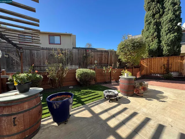 a view of a patio with table and chairs and potted plants