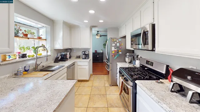 a kitchen with a stove a sink and a refrigerator