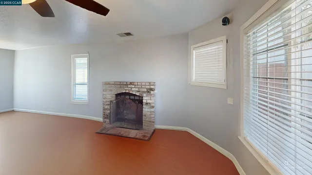 a view of a livingroom with a fireplace and window