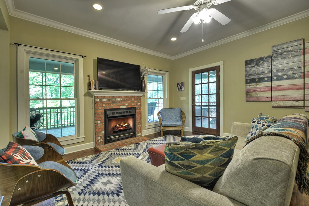 604 Ensley Road Epworth, GA 30541 - Photo 11 of 60 a living room with furniture a flat screen tv and a fireplace