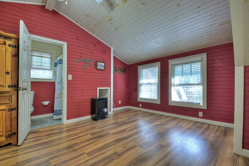 604 Ensley Road Epworth, GA 30541 - Photo 45 of 60 a view of empty room with wooden floor and fan