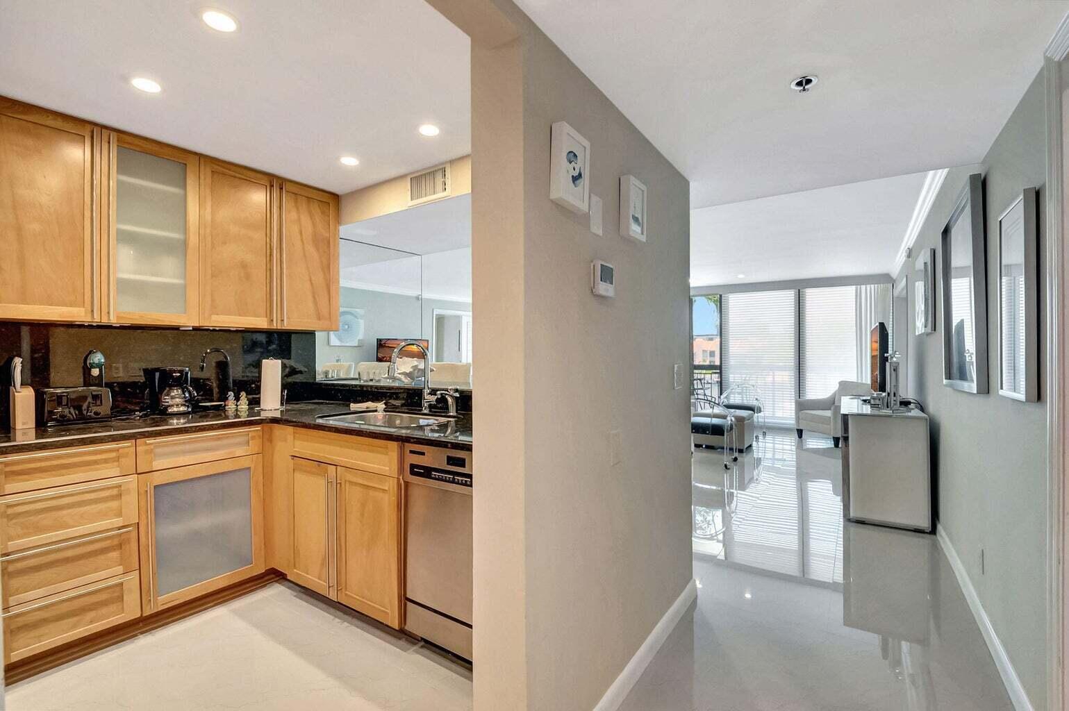 2707 North Ocean Boulevard, Unit D205 Boca Raton, FL 33431 - Photo 4 of 51 a kitchen with stainless steel appliances granite countertop a stove a sink and a refrigerator