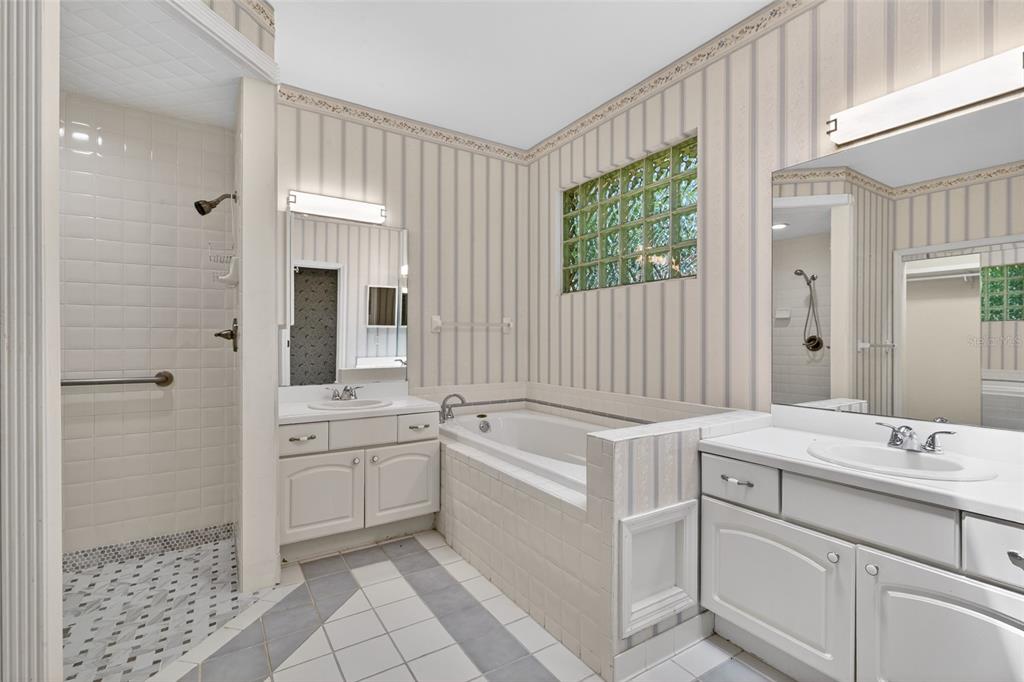9626 Southwest 53rd Road Gainesville, FL 32608 - Photo 14 of 23 a bathroom with a sink a toilet a mirror and shower