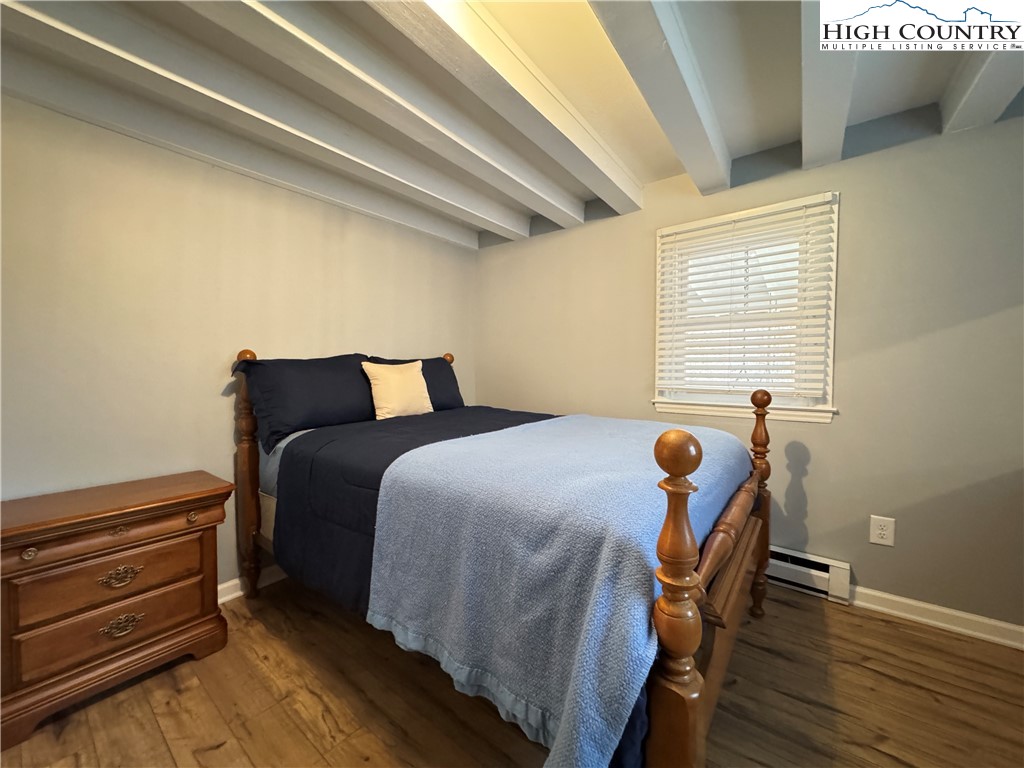 321 Skin Camp Creek Road Todd, NC 28684 - Photo 14 of 29 a bedroom with furniture and wooden floor