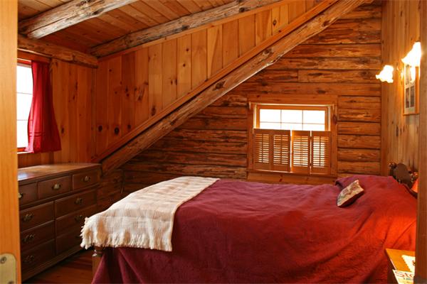 115 Secret Lake Road Phillipston, MA 01331 - Photo 14 of 20 a bed sitting in a bedroom next to a window