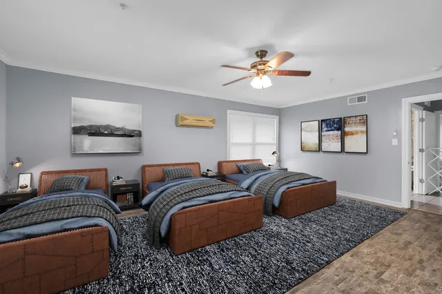 a bedroom with two beds and a chandelier