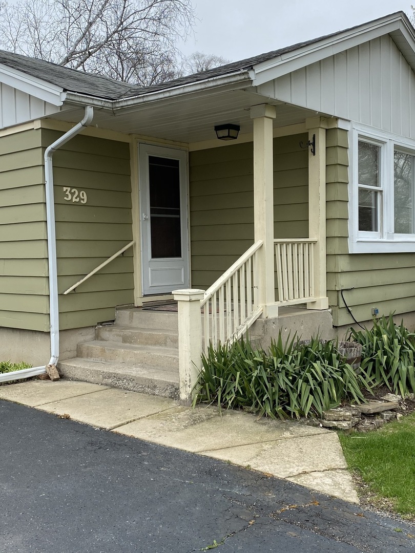 329 Douglas Road Batavia, IL 60510 - Photo 2 of 23 a view of entrance gate of house and tree