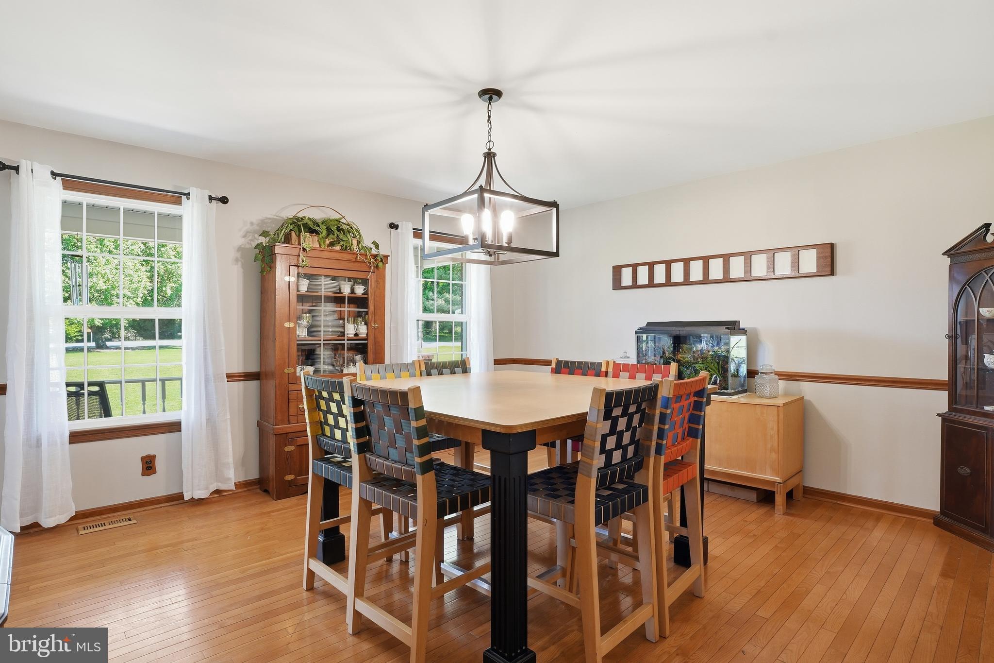 6118 Fishers Station Road Lothian, MD 20711 - Photo 16 of 62 a view of a dining room with furniture window and wooden floor