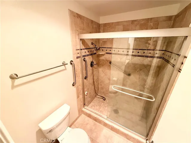a bathroom with a shower and toilet