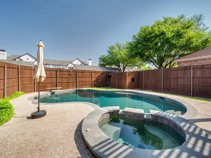 a view of a backyard with swimming pool