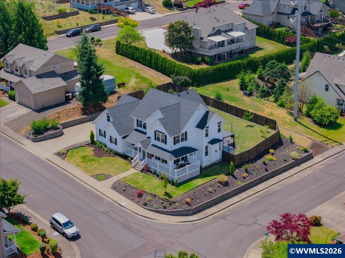 an aerial view of a house with a garden and outdoor seating