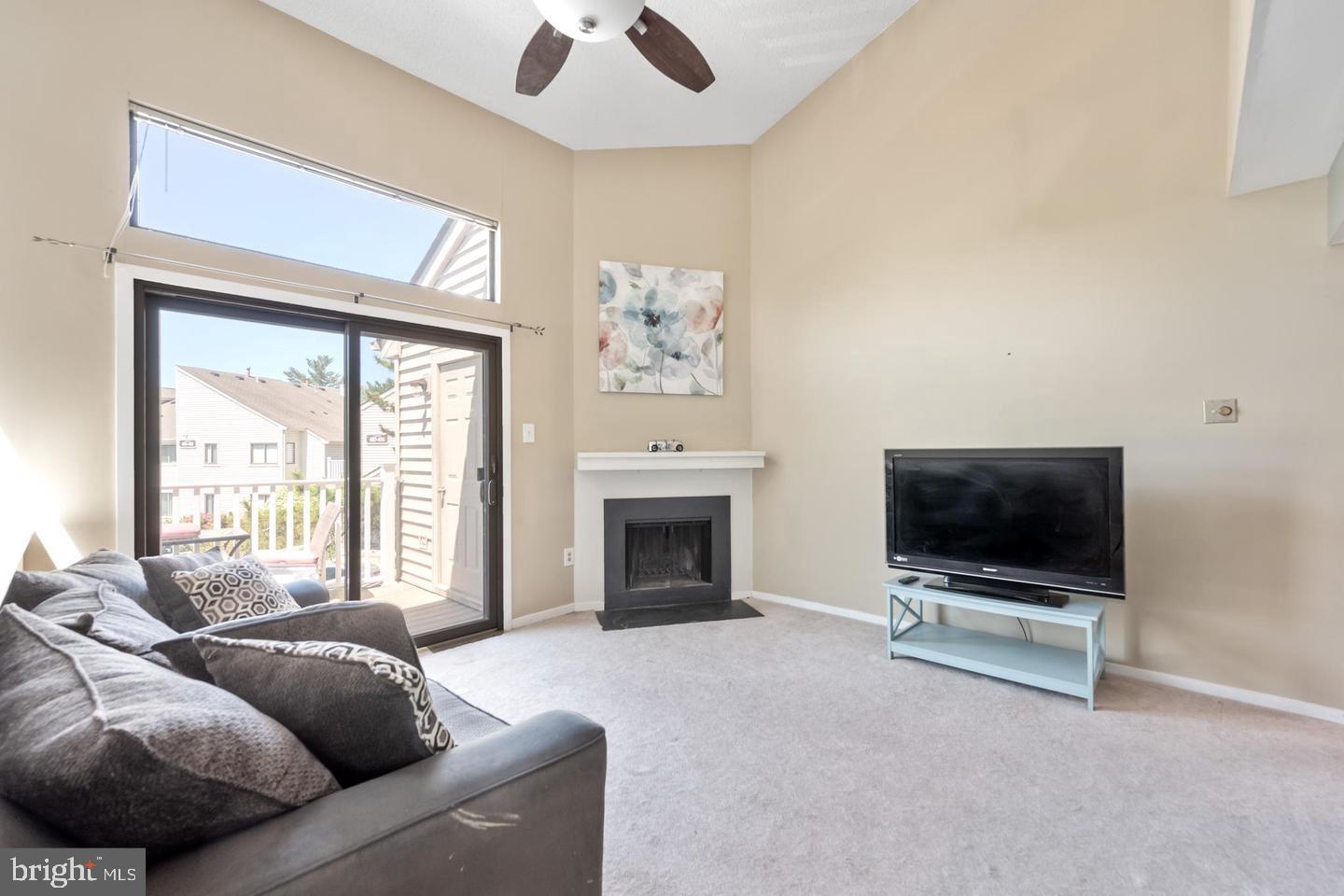 502 Gregorys Way Voorhees, NJ 08043 - Photo 6 of 8 a living room with furniture a flat screen tv and a fireplace