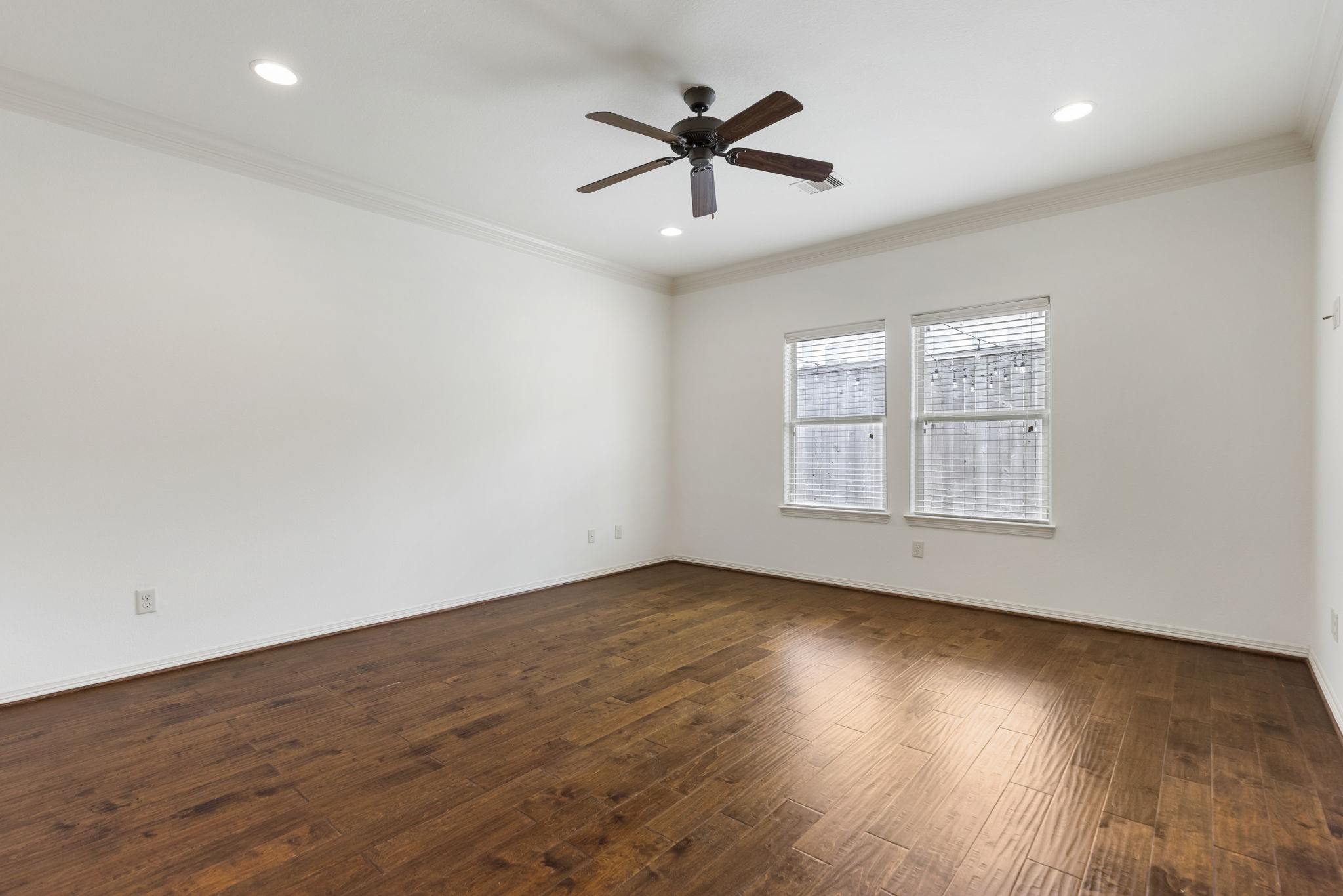 23911 Augusta Falls Lane Spring, TX 77389 - Photo 15 of 40 an empty room with wooden floor ceiling fan and windows