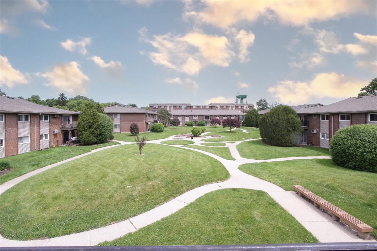 2300 Old Tavern Road, Unit 203 Lisle, IL 60532 - Photo 23 of 26 a view of a house with a big yard and a large trees