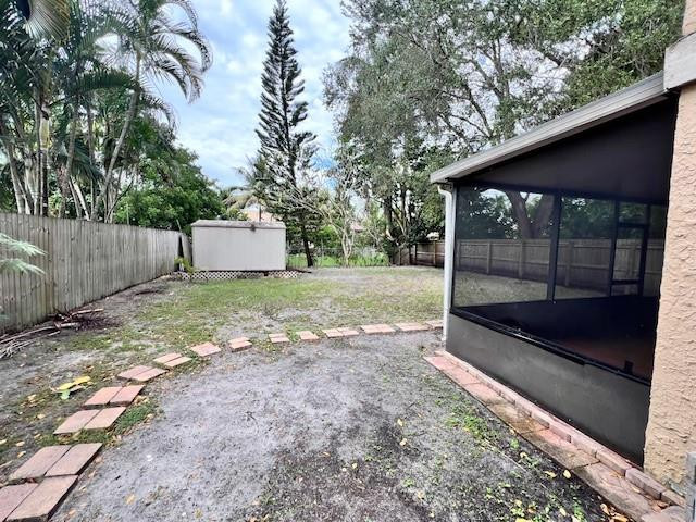 8331 Southwest 39th Court, Unit 8331 Fort Lauderdale, FL 33328 - Photo 42 of 44 a view of a backyard with large trees and wooden fence