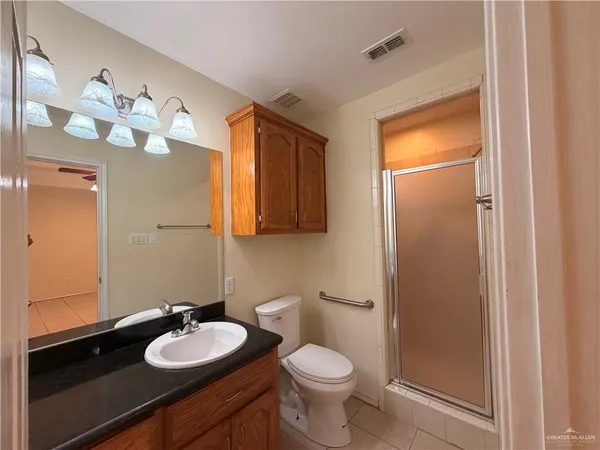 a bathroom with a sink a toilet and mirror