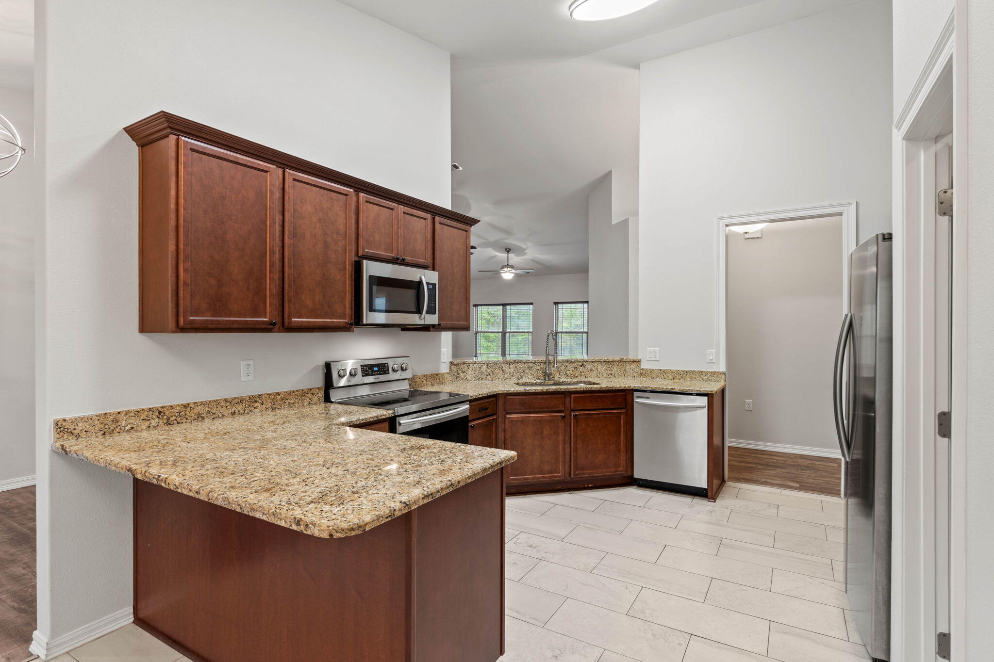 6000 Fiori Drive Crestview, FL 32539 - Photo 11 of 44 a kitchen with granite countertop a sink stove and refrigerator
