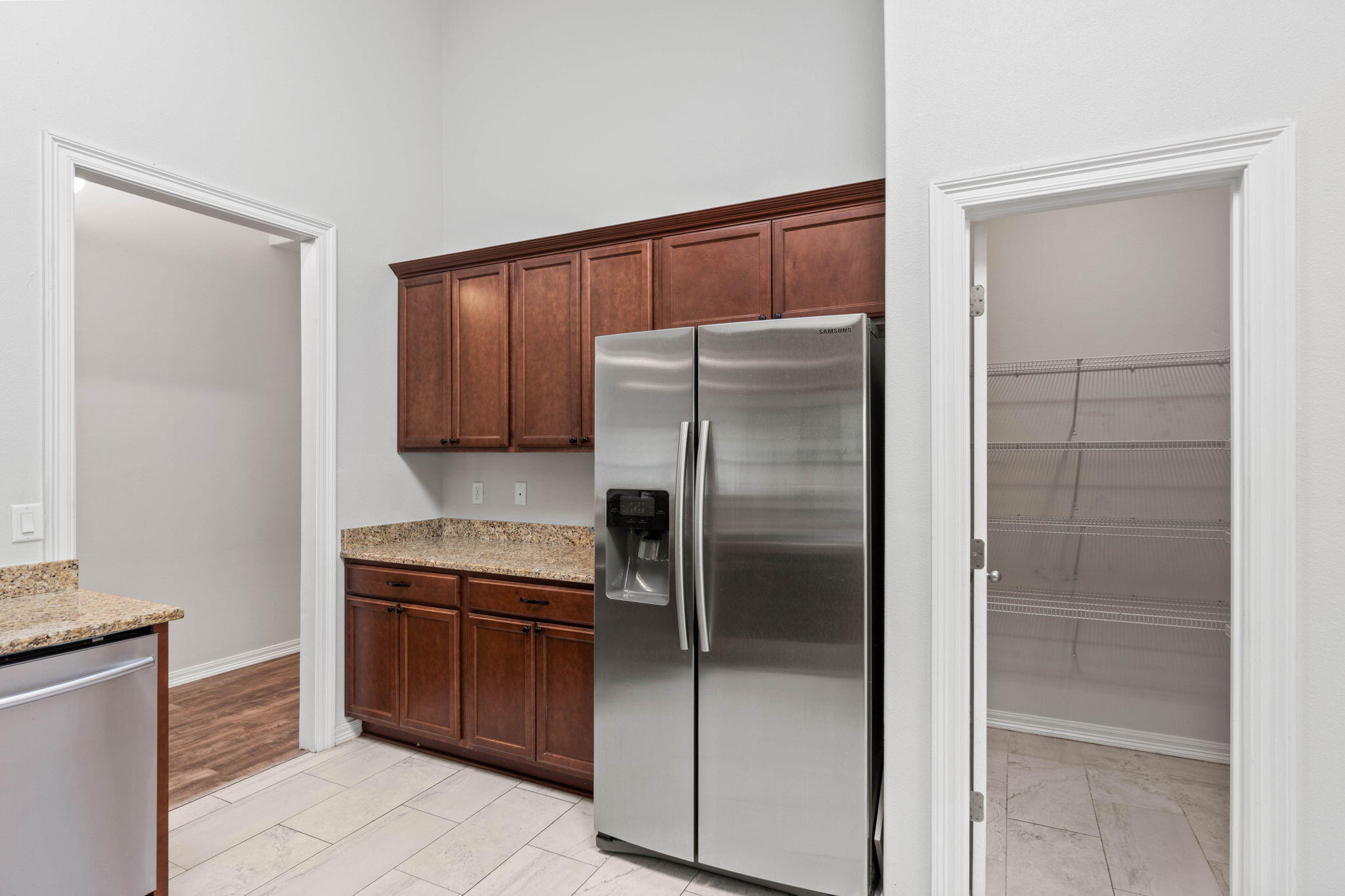 6000 Fiori Drive Crestview, FL 32539 - Photo 13 of 44 a kitchen with granite countertop a refrigerator and a sink