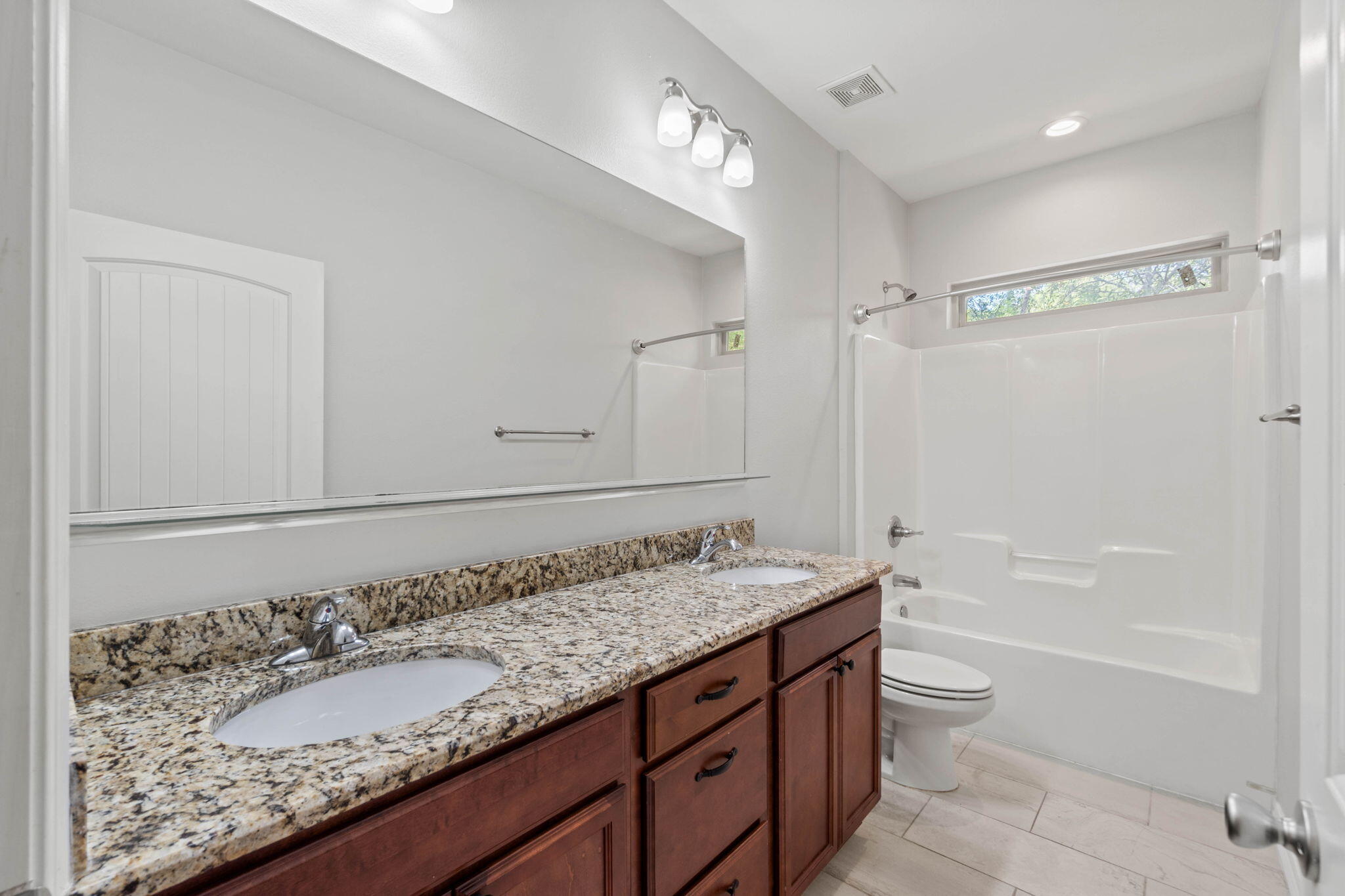 6000 Fiori Drive Crestview, FL 32539 - Photo 16 of 44 a bathroom with a granite countertop sink mirror vanity and bathtub