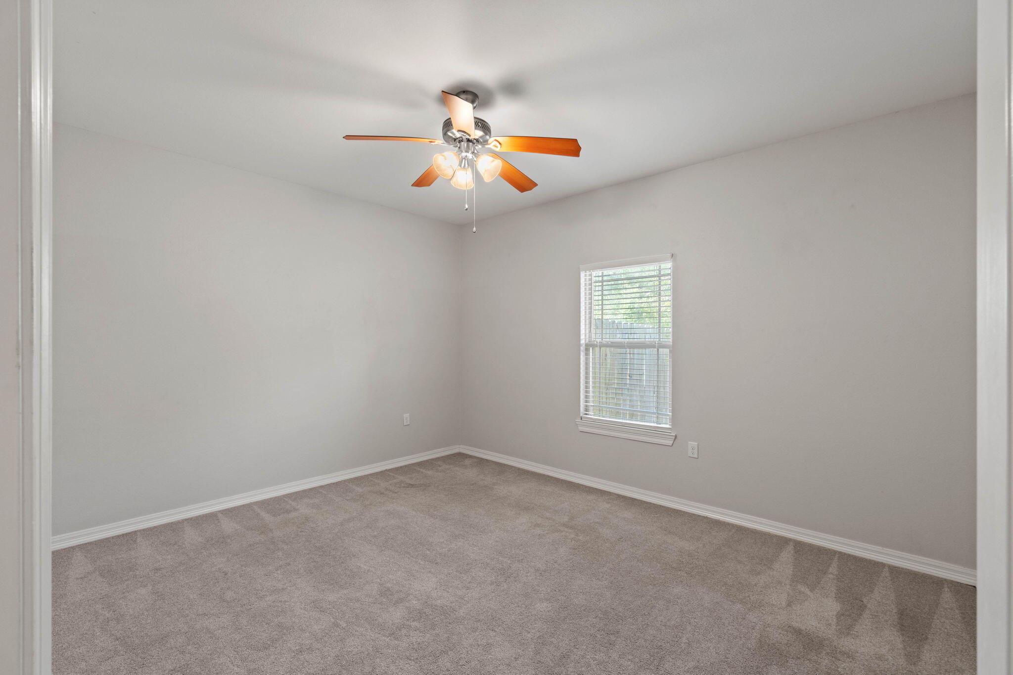 6000 Fiori Drive Crestview, FL 32539 - Photo 17 of 44 an empty room with windows and chandelier fan
