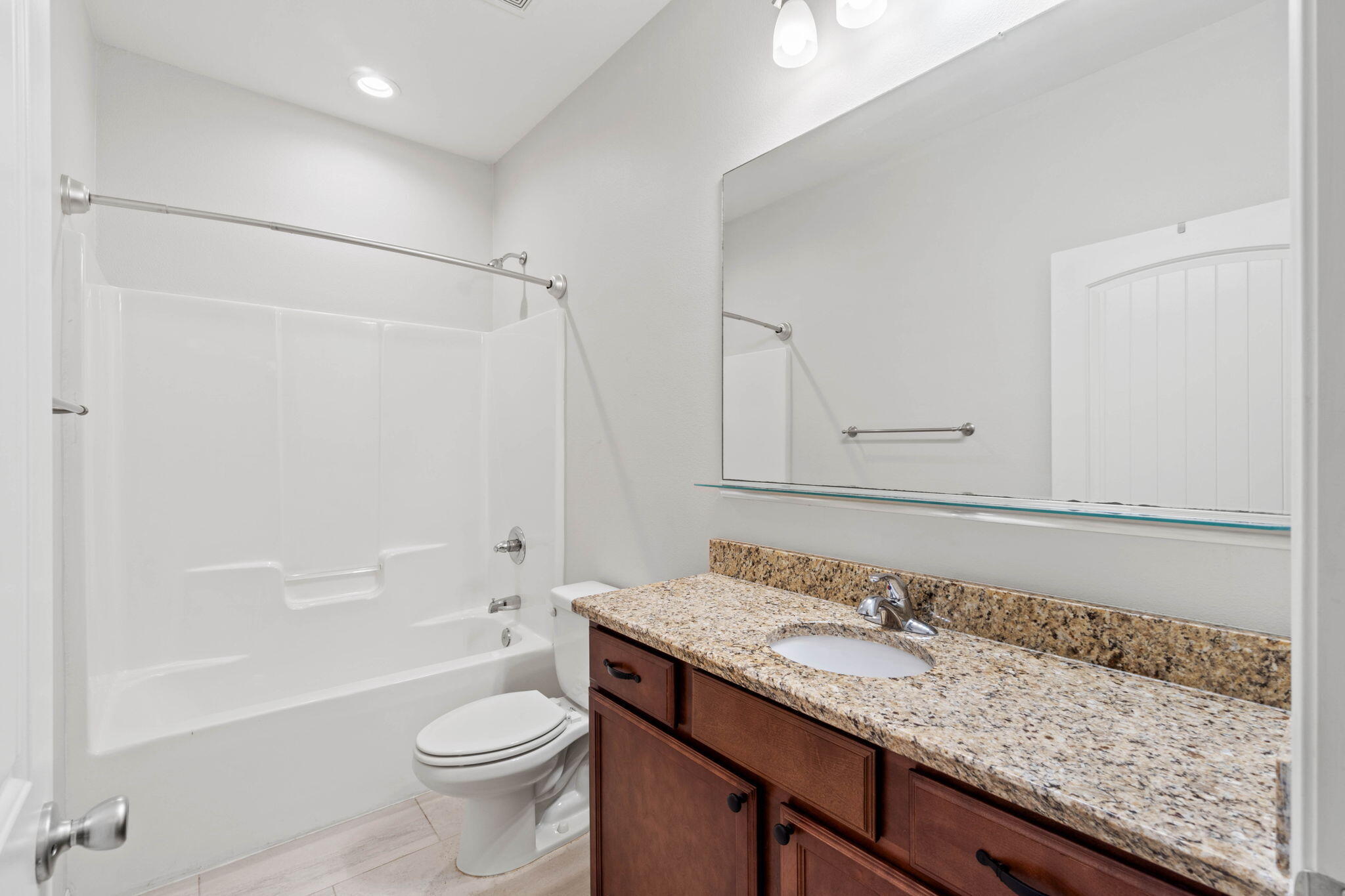 6000 Fiori Drive Crestview, FL 32539 - Photo 19 of 44 a bathroom with a granite countertop sink a toilet and shower