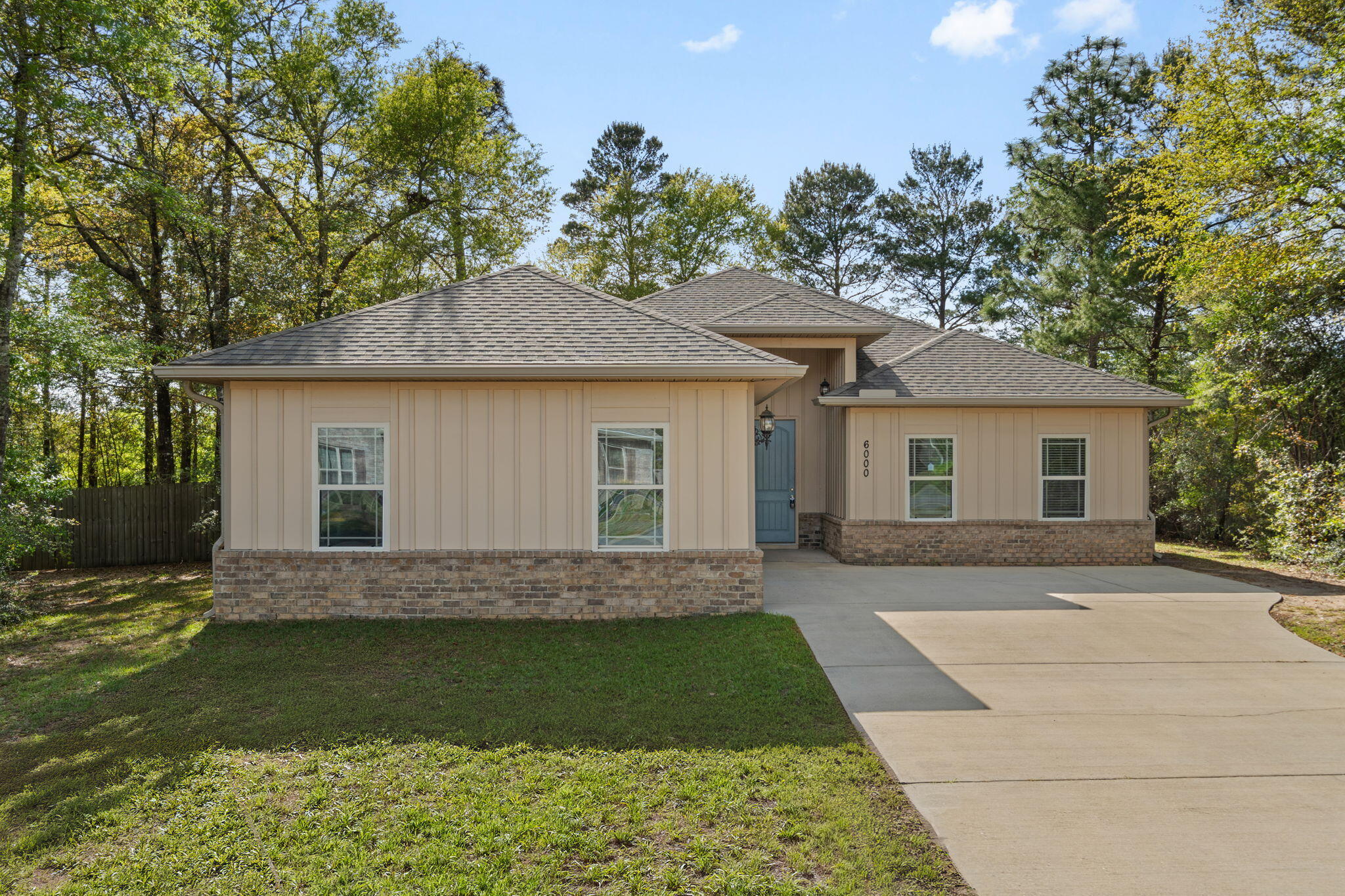 6000 Fiori Drive Crestview, FL 32539 - Photo 2 of 44 a front view of a house with a garden