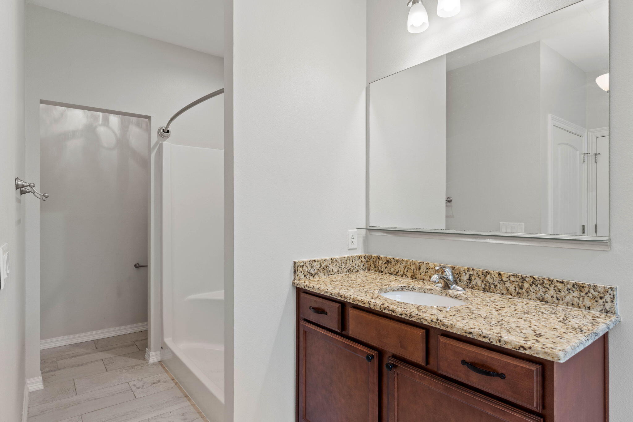6000 Fiori Drive Crestview, FL 32539 - Photo 25 of 44 a bathroom with a granite countertop sink and a mirror
