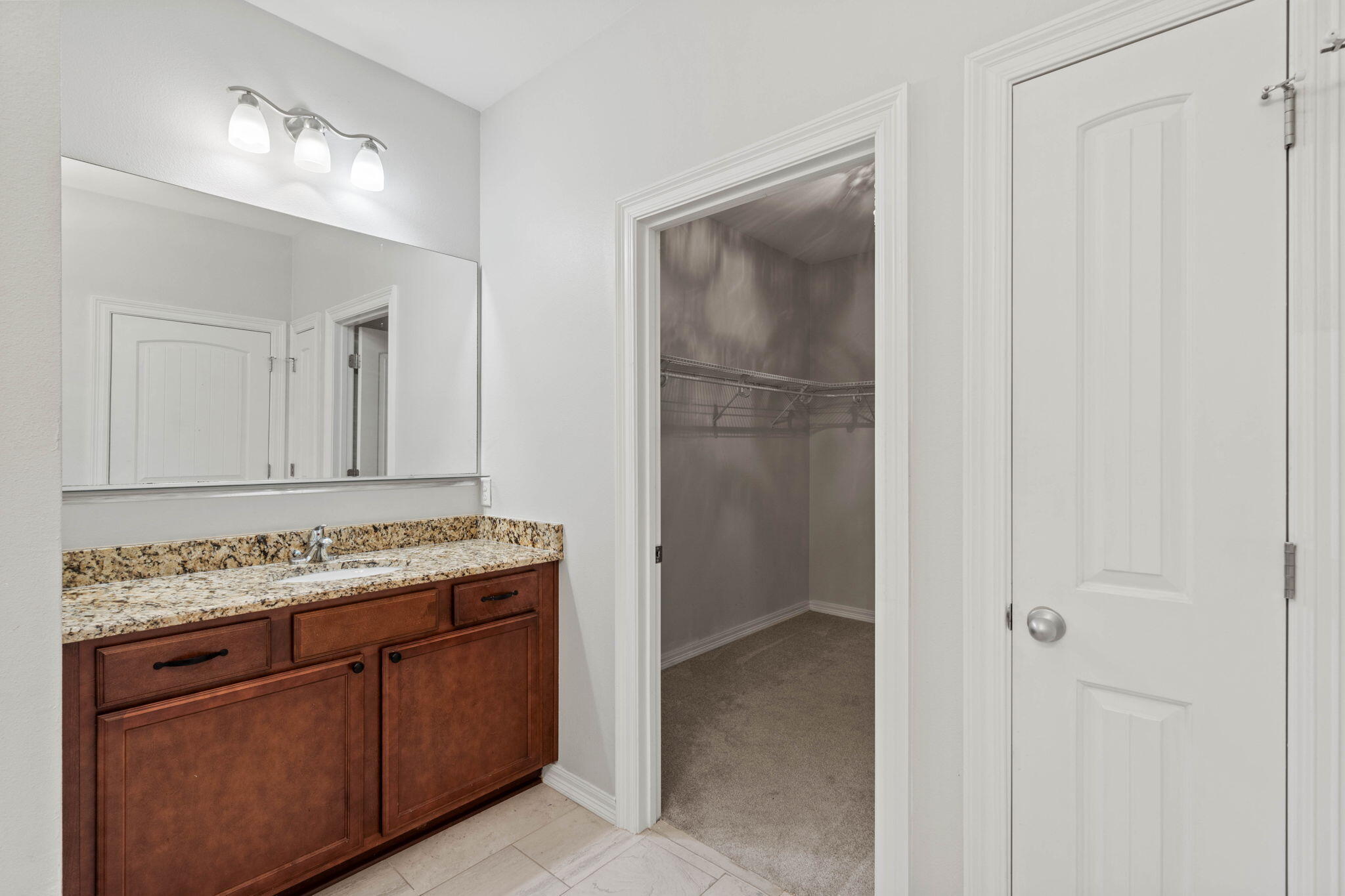 6000 Fiori Drive Crestview, FL 32539 - Photo 27 of 44 a bathroom with a granite countertop sink and a mirror