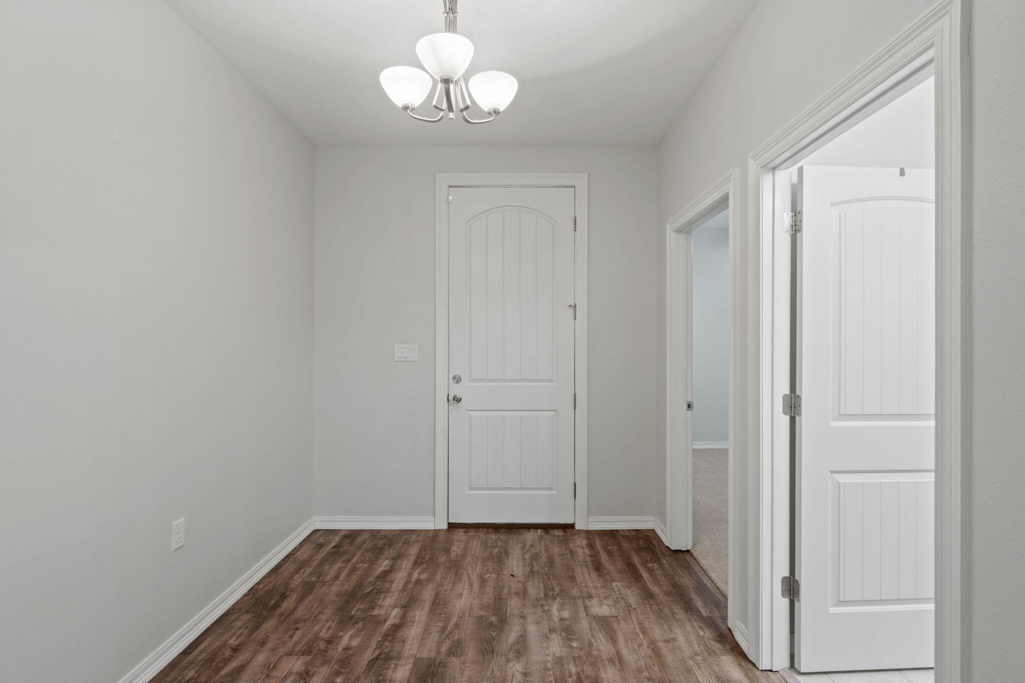 6000 Fiori Drive Crestview, FL 32539 - Photo 4 of 44 wooden floor in an empty room with a window