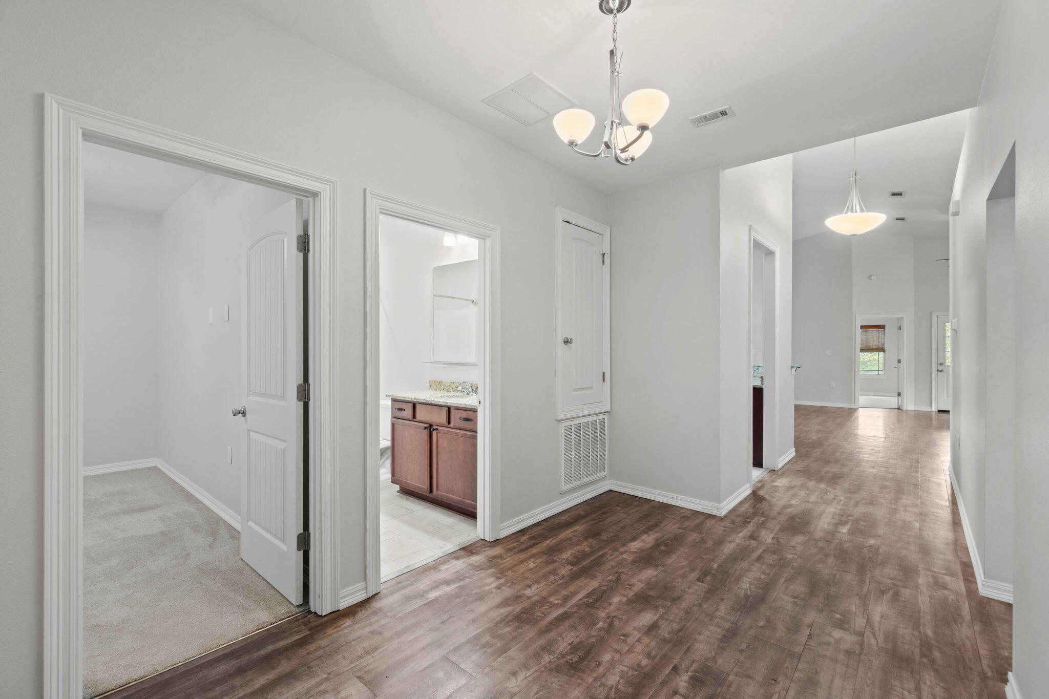 6000 Fiori Drive Crestview, FL 32539 - Photo 5 of 44 a view of a hallway with wooden floor and a bathroom