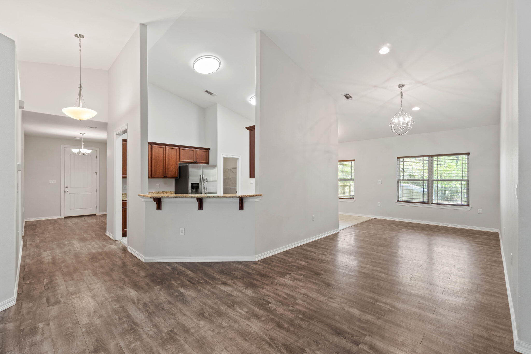 6000 Fiori Drive Crestview, FL 32539 - Photo 8 of 44 an empty room with wooden floor and windows