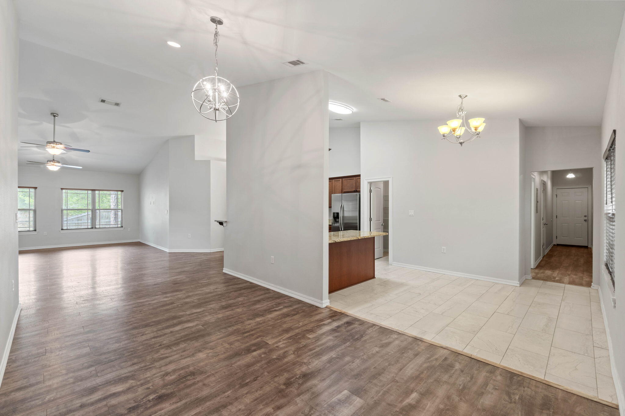 6000 Fiori Drive Crestview, FL 32539 - Photo 9 of 44 wooden floor in an empty room with a window
