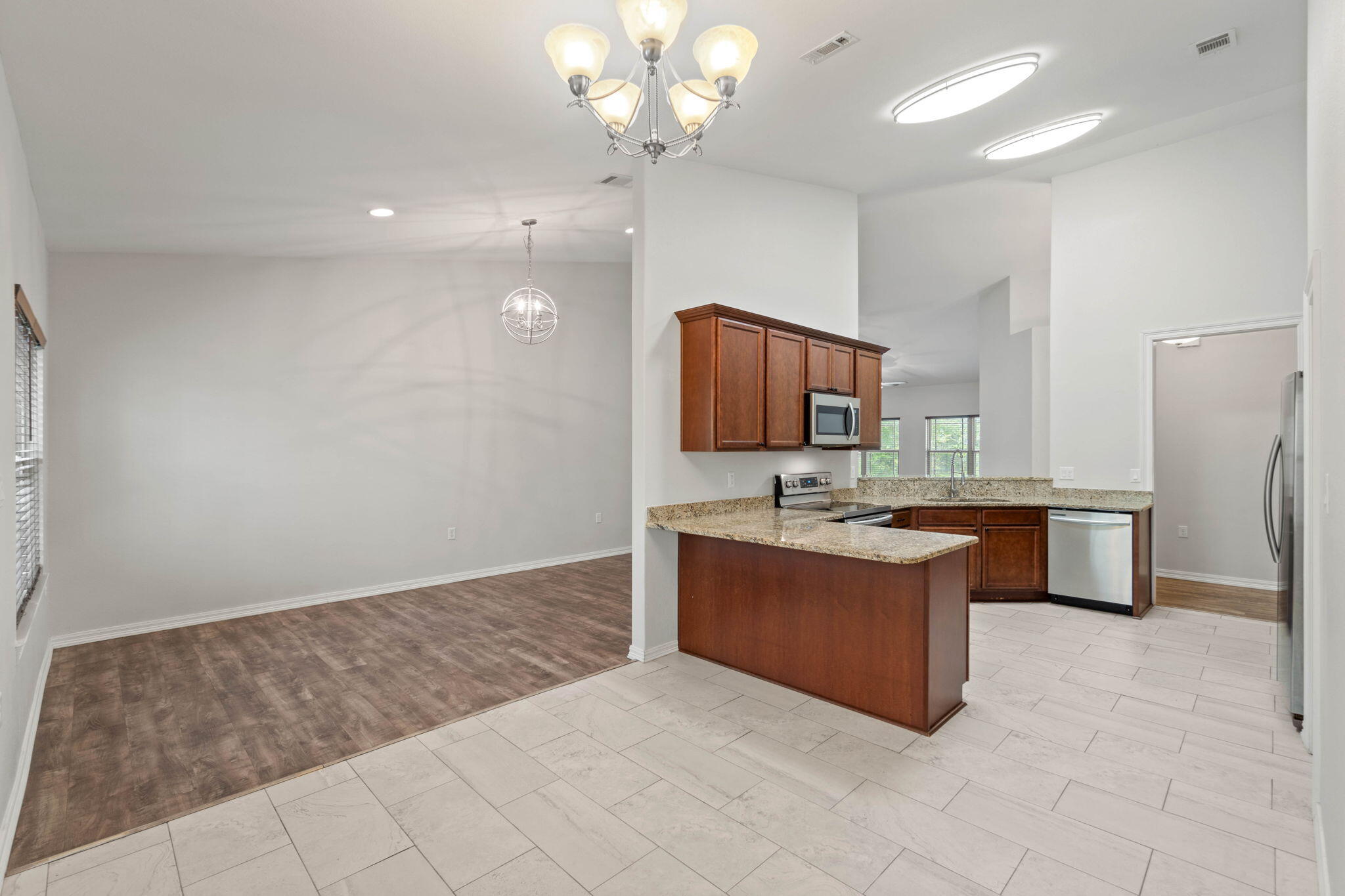 6000 Fiori Drive Crestview, FL 32539 - Photo 10 of 44 a large kitchen with a sink and a stove top oven